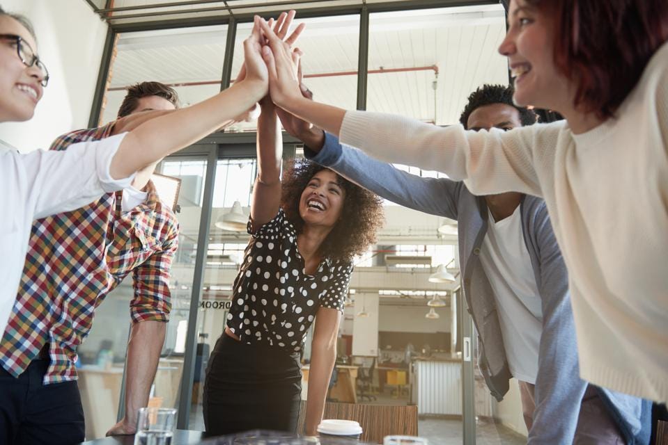 team of people high-fiving in the center