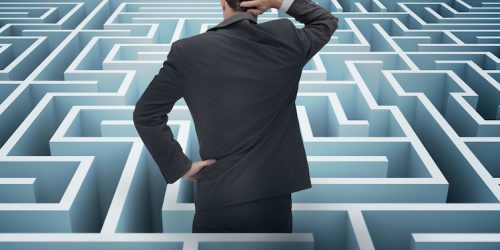 Back of businessman getting lost in a maze