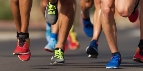 Marathon running race, people feet on city road