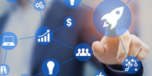 Startup business concept showing the steps and phases to launch a start-up company - Businessman touching a button with a rocket icon linked with other ideas on a screen interface
