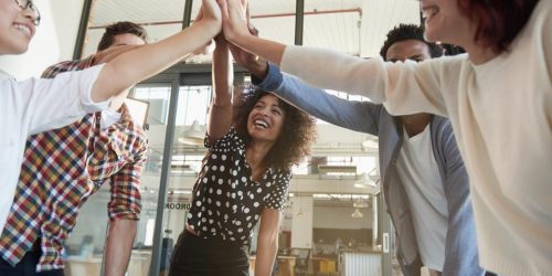 team of people high-fiving in the center